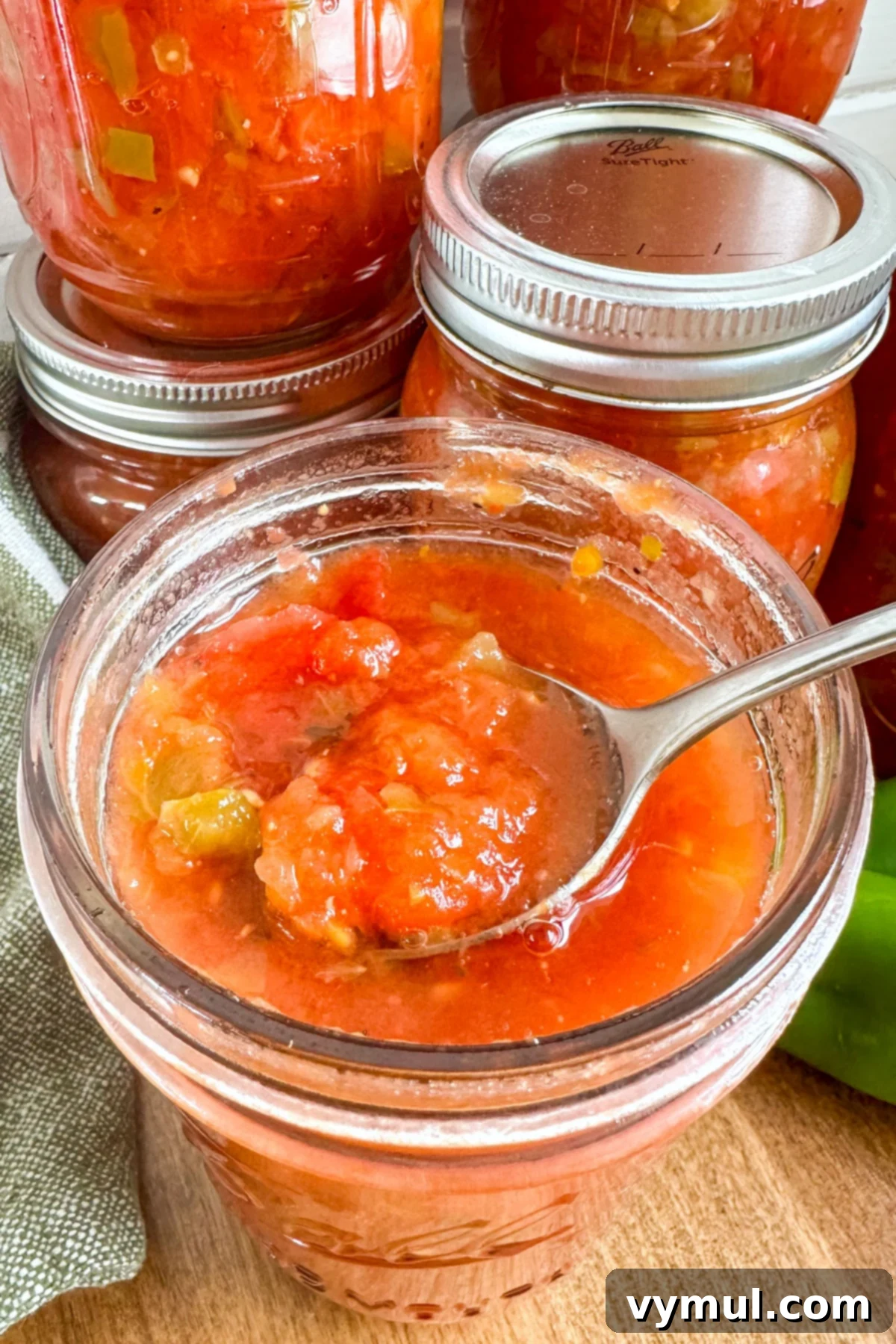 Homemade Rotel-Style Tomato and Green Chili Mix 2 Rotel recipe in open jar with spoon