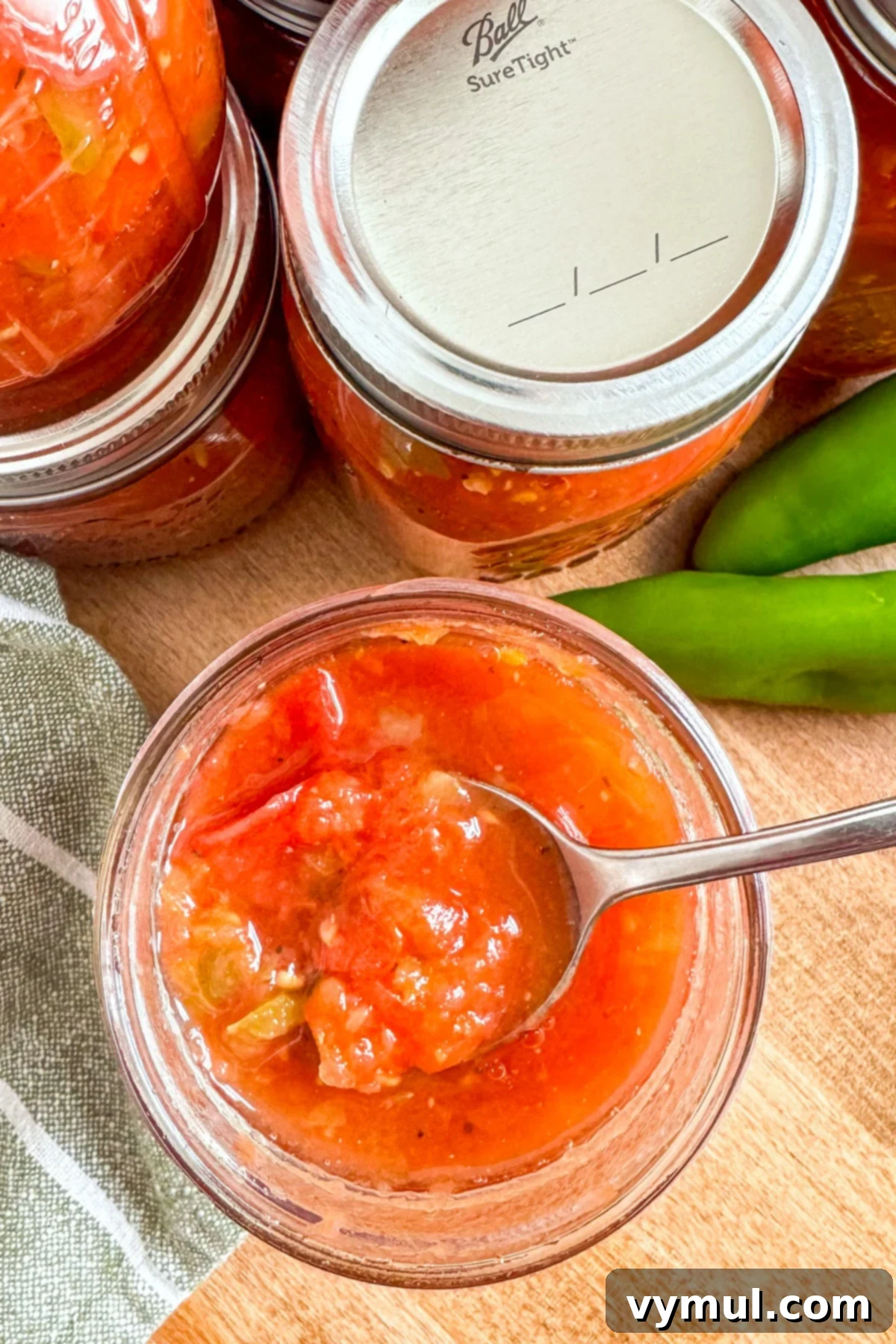 Homemade Rotel-Style Tomato and Green Chili Mix 11 open jar of Rotel style tomatoes with spoon