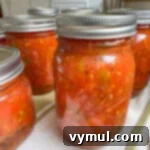 Homemade Rotel-Style Tomato and Green Chili Mix 12 jars of Rotel on towel-lined counter