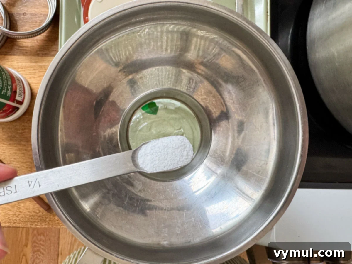 Homemade Rotel-Style Tomato and Green Chili Mix 7 adding citric acid to jar