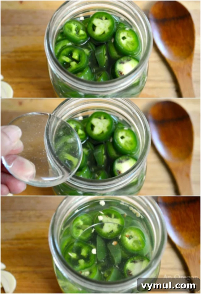 Effortless Fermented Jalapeño Pickles 5 A glass fermentation weight holding down sliced jalapeños under brine in a mason jar