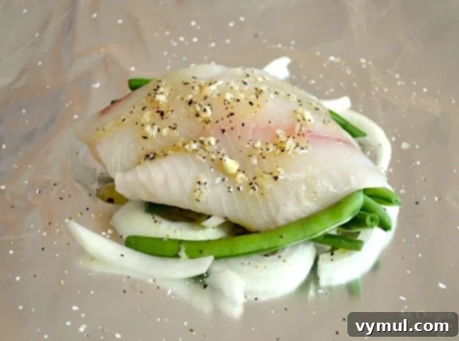 Zesty Lemon Fish and Veggie Grill or Bake Packets 4 Lemon Vegetable Fish Foil Packets-fish fillet placed on top of vegetables