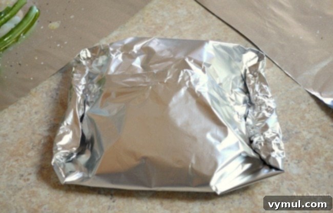 Zesty Lemon Fish and Veggie Grill or Bake Packets 6 Lemon Vegetable Fish Foil Packets-folded foil packet ready for cooking