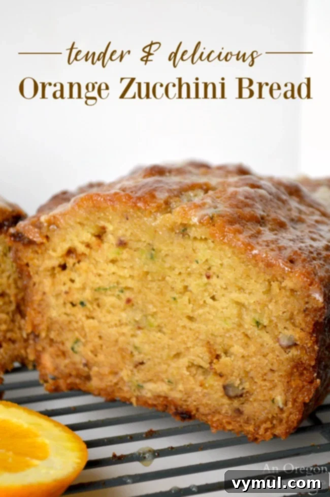 Orange Zucchini Bread Recipe - perfectly baked loaf with a slice missing