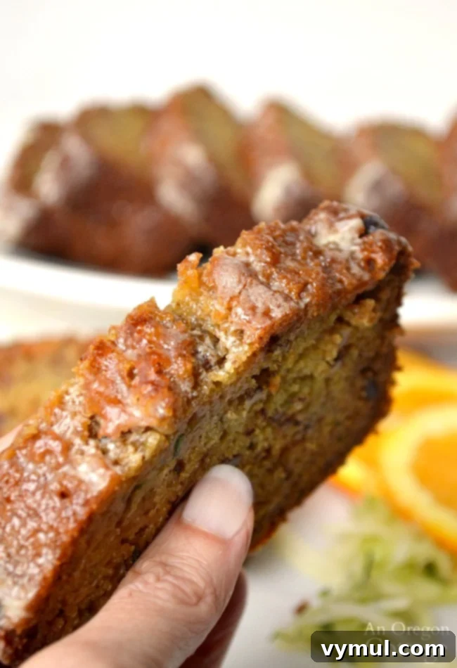 A perfectly baked slice of orange zucchini bread with honey and whole wheat