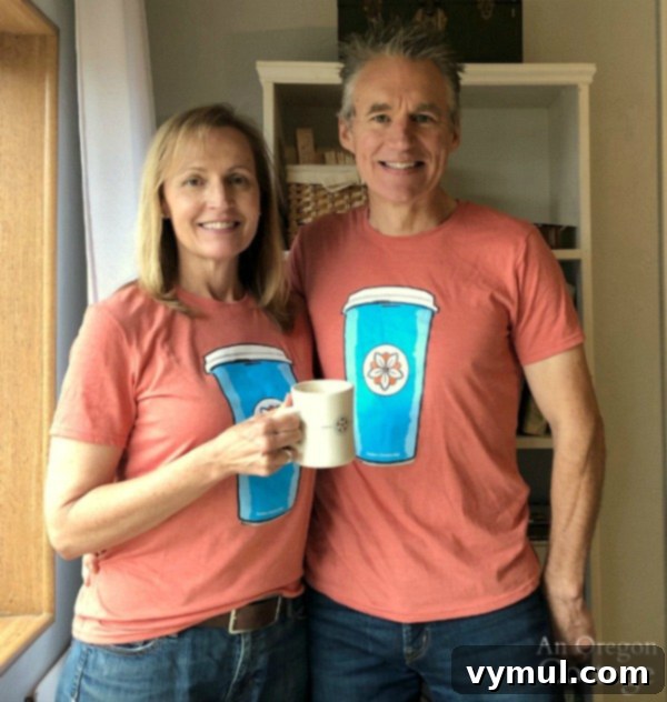 Brian wearing a coffee shirt, holding a mug, featuring Batdorf & Bronson Coffee