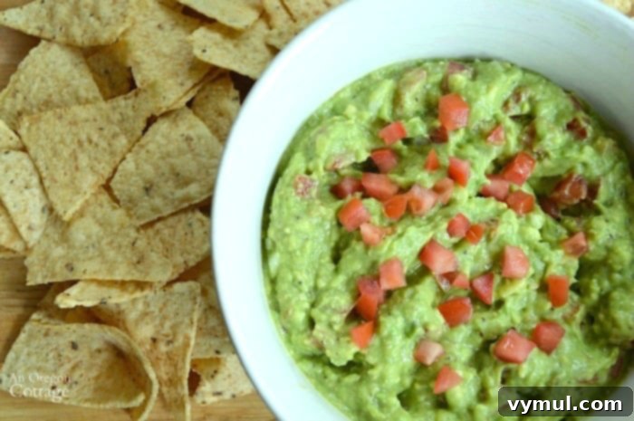 Sixty Plus Fast Healthy Recipes for Simple Meal Prep 3 Freshly made Chunky Guacamole with tortilla chips on a rustic wooden board, perfect for a quick and healthy snack.