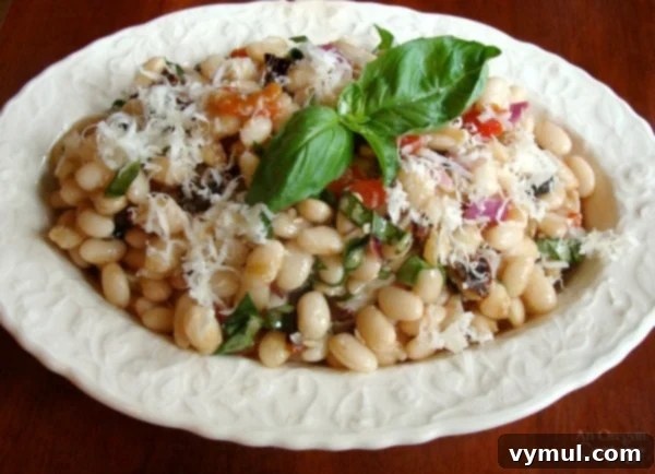 Sixty Plus Fast Healthy Recipes for Simple Meal Prep 9 A refreshing Tuscan White Bean Salad in a bowl, garnished with fresh herbs, ideal for a quick and light meal.