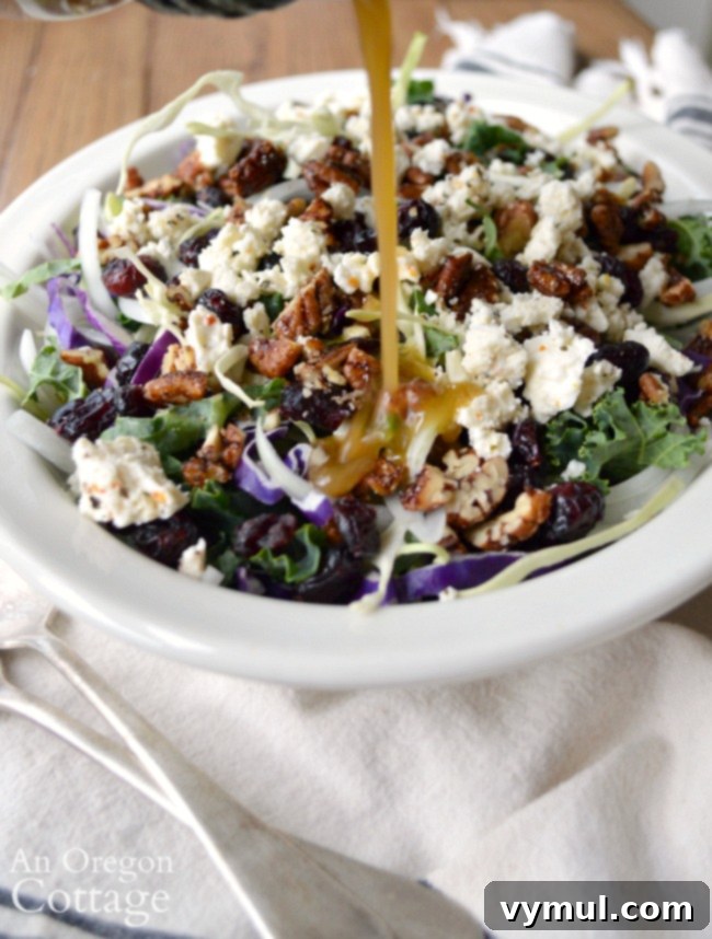 Pouring homemade balsamic vinaigrette over Kale Cranberry Salad