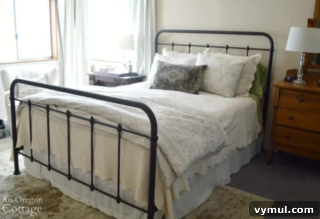 Elegant farmhouse style metal bed frame with white bedding, highlighting affordable home decor