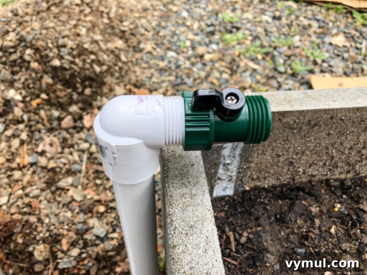 Budget Garden Watering Made Easy 12 green on/off valve attached to pvc pipe at raised bed
