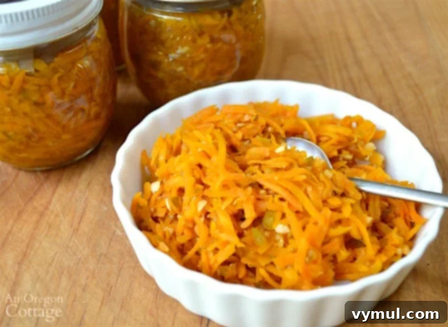 Easy freezer hot and sweet carrot relish in a glass jar, ready for preserving