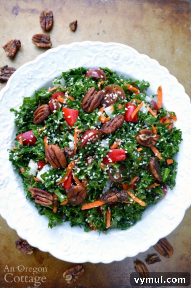 Bursting with flavor, this kale and vegetable salad with sesame and pecans is perfect with both grilled and baked foods. Bonus is it's really good for you, too.