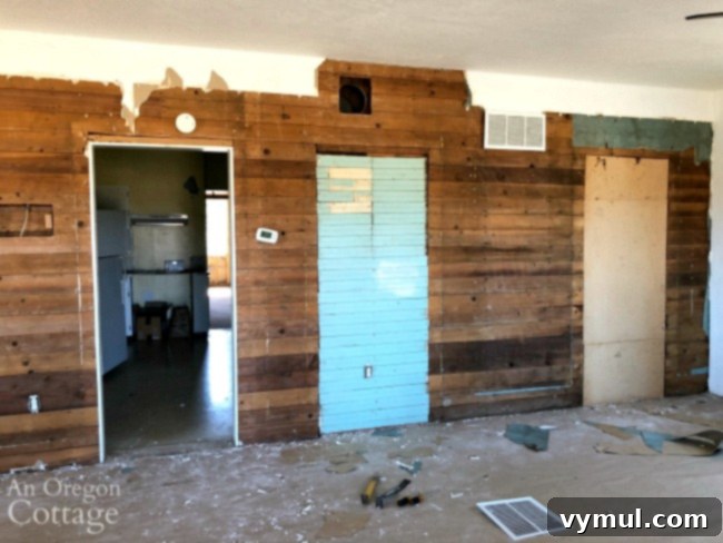 Farmhouse living room wall with original wood revealed after removing wallboard