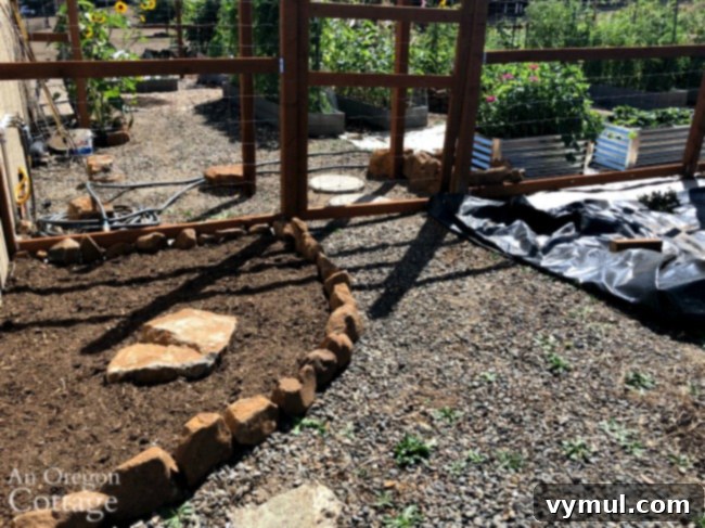 Low-maintenance vegetable garden with deer fence in its first year of successful growth