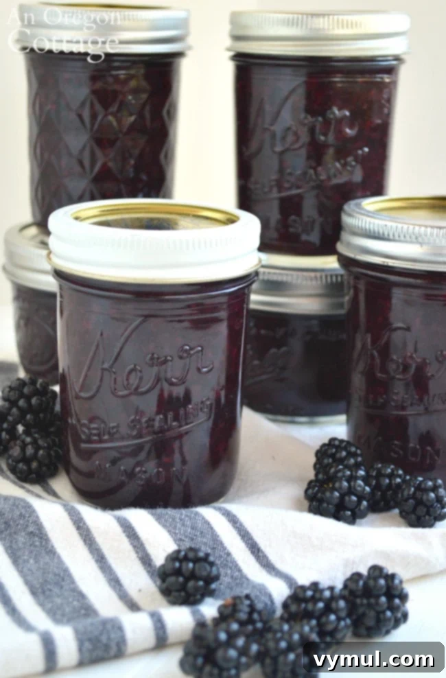 jars of blackberry jam on striped towel