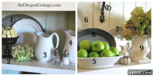 Thrifted Shelf Styling Details Close-up of a styled shelf with thrifted items, including a pewter tray, white plates, and a dark glass bowl.