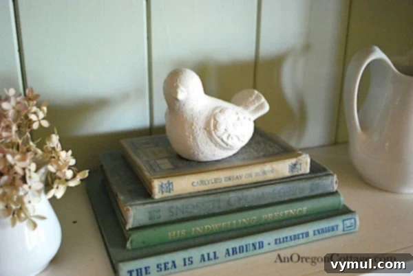 White painted dove figurine on books, a successful thrift store upcycle