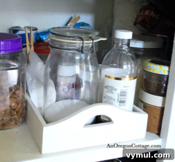 Wooden tray organizing baking ingredients in a kitchen cabinet