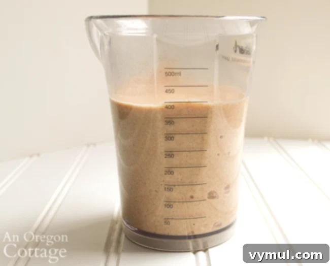 A glass jar filled with sourdough starter discard, ready to be used in a delicious coffee cake recipe.