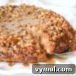 A delicious slice of sticky bun sourdough coffee cake, topped with caramel and pecans, ready to be served.