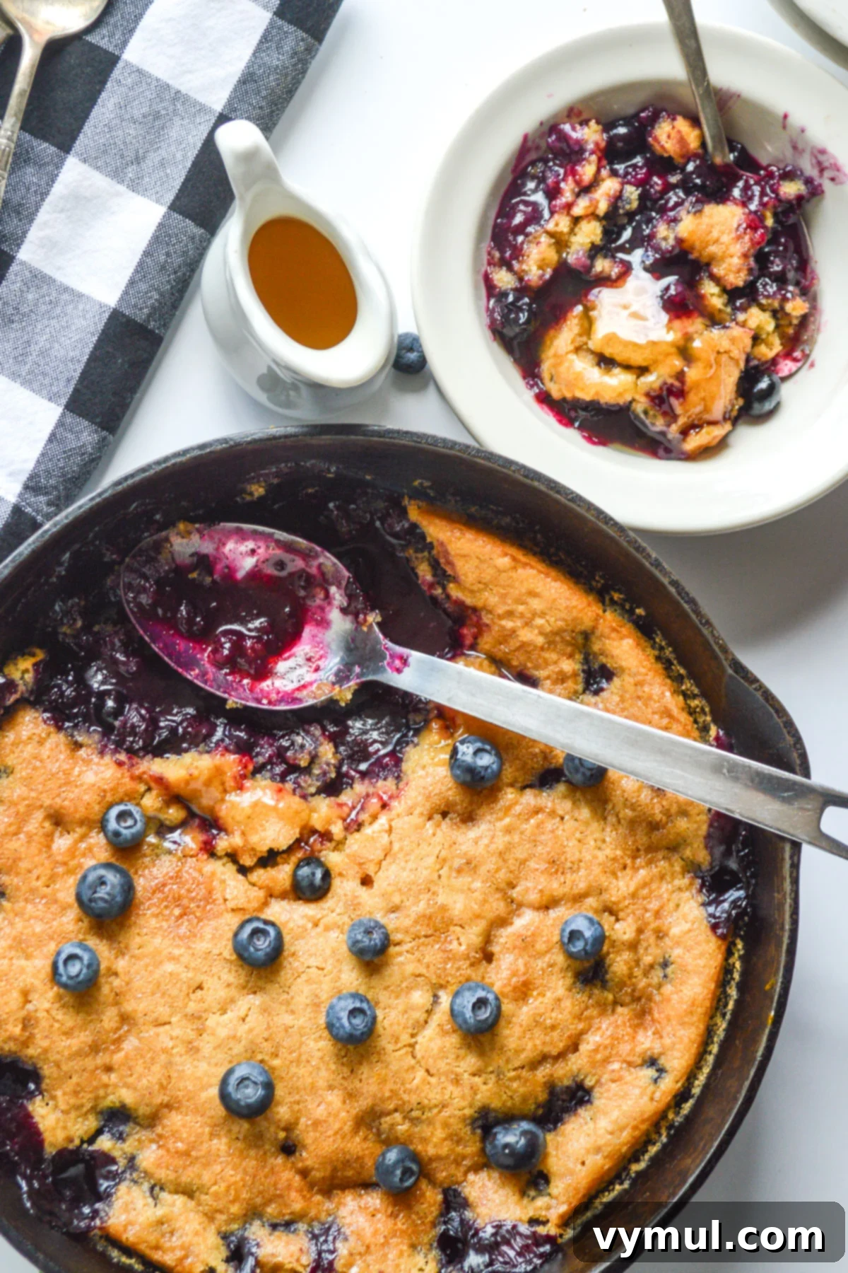 serving blueberry cobbler from skillet