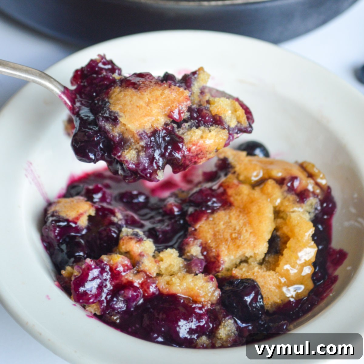 eating blueberry cobbler from a bowl