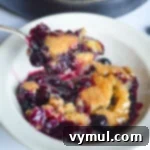 eating blueberry cobbler from a bowl