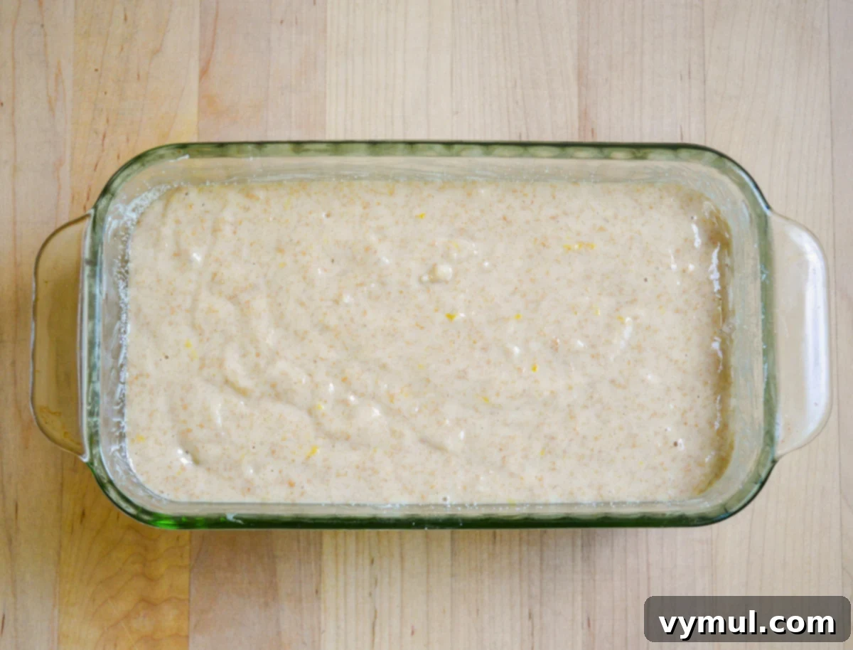 Bright Lemon Sourdough Loaf from Discard 6 Lemon bread batter poured into a loaf pan, ready for baking.