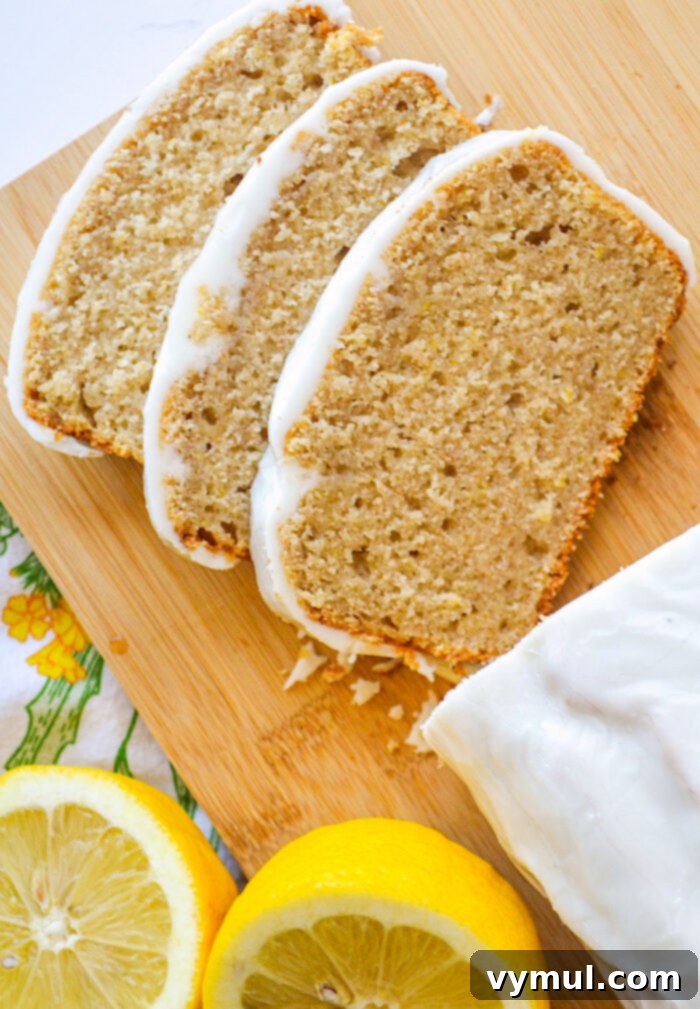 Bright Lemon Sourdough Loaf from Discard 8 Slices of sourdough lemon bread arranged on a cutting board with a fresh lemon cut in half.