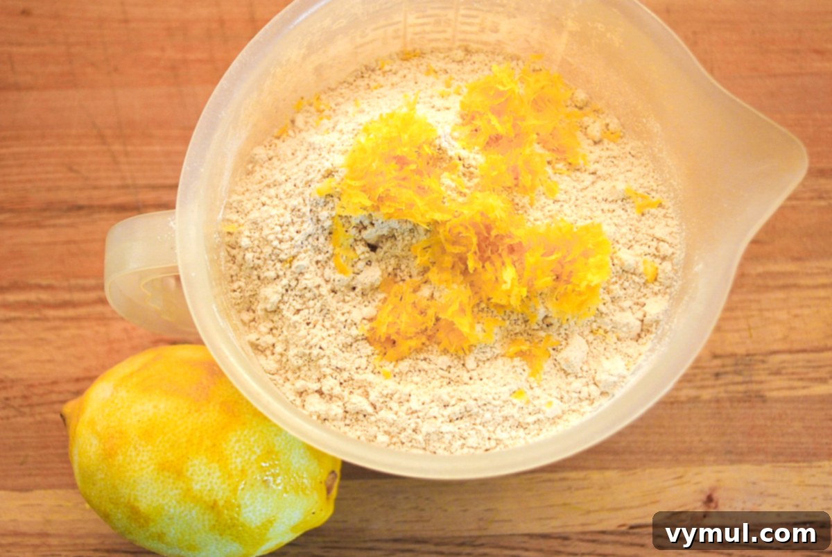 Dry ingredients for zucchini lemon bread, including flour and spices, measured and ready in a bowl.