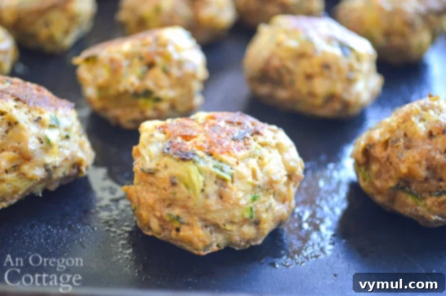 Close-up of perfectly cooked zucchini meatballs, showing their tender texture and delicious appearance.