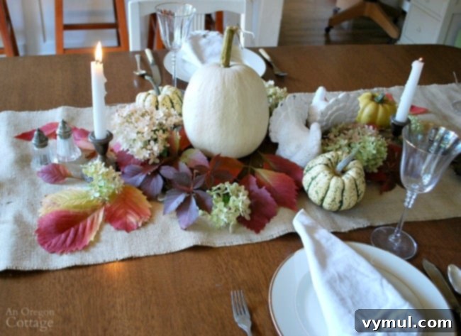 Simple white nature inspired Thanksgiving table setting with white pumpkins and greenery