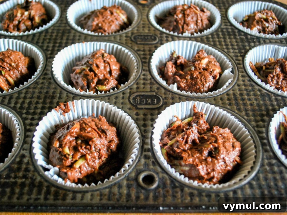 Secretly Healthy Chocolate Zucchini Cupcakes 4 Cupcake batter divided evenly between liners in a muffin pan