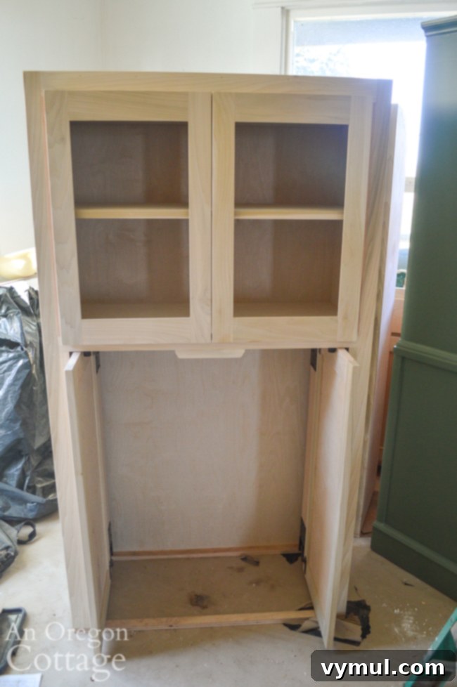Mid-Year 3 Farmhouse Progress Tour 5 custom coffee bar cabinet with pocket doors on bottom and glass doors on top.