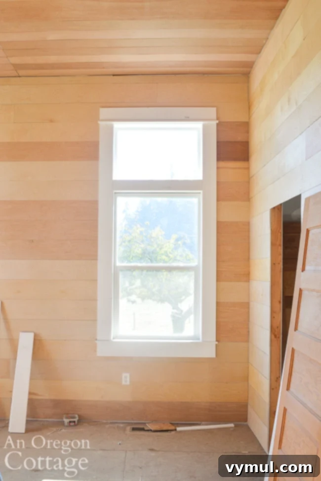 Mid-Year 3 Farmhouse Progress Tour 9 farmhouse master bed unpainted wood walls and window