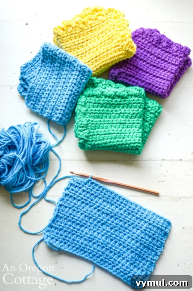Close-up of a person crocheting an unpaper towel, highlighting the simple stitch pattern.