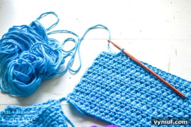 Crochet unpaper towels neatly folded and stacked in a charming gift basket.