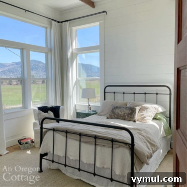Farmhouse Moving Day: Vintage Finds, Cozy Linens, and Literary Treasures 7 farmhouse bedroom with large windows, iron bed, and wood clad walls