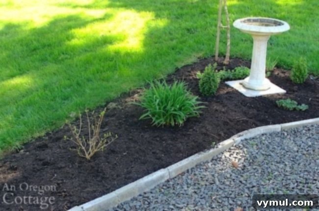 A lush flower bed expertly mulched with compost, showcasing healthy plant growth and effective weed control.