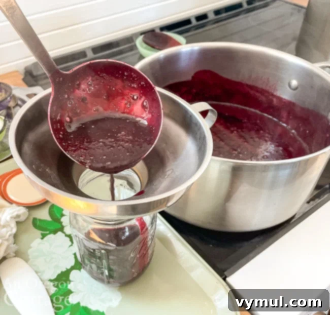 adding blueberry syrup to canning jars