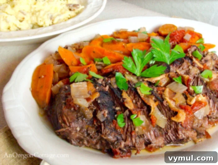 Rustic Italian Slow Cooker Pot Roast 4 beef roast on white platter with carrots