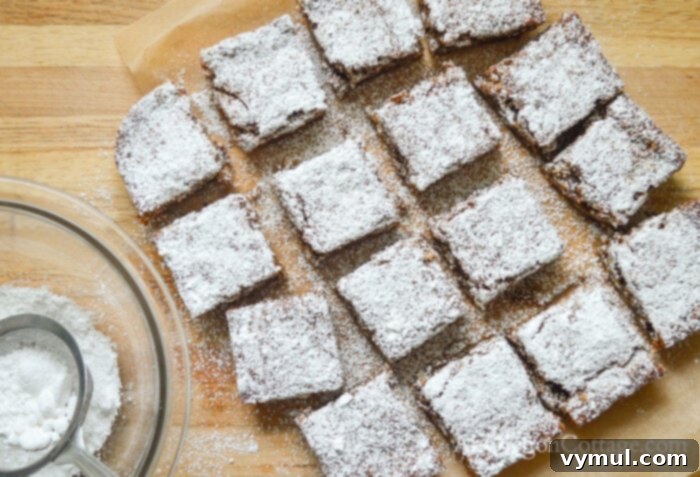 Flourless Chewy Noels Bars A Fresh Take on Christmas Cookie Classics 7 Freshly cut Christmas Noel cookies on a cutting board.