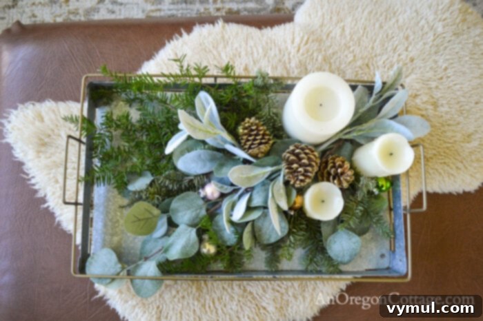 Christmas coffee table decor with battery-operated candles, greenery, and ornaments