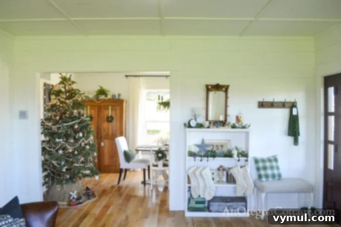 View from entryway into dining room with Christmas tree and decor