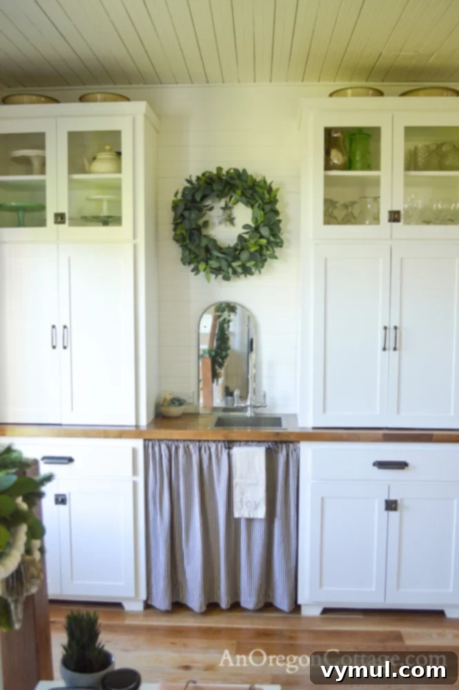 Renovated 1900 farmhouse kitchen coffee bar cabinets with sink, decorated for Christmas