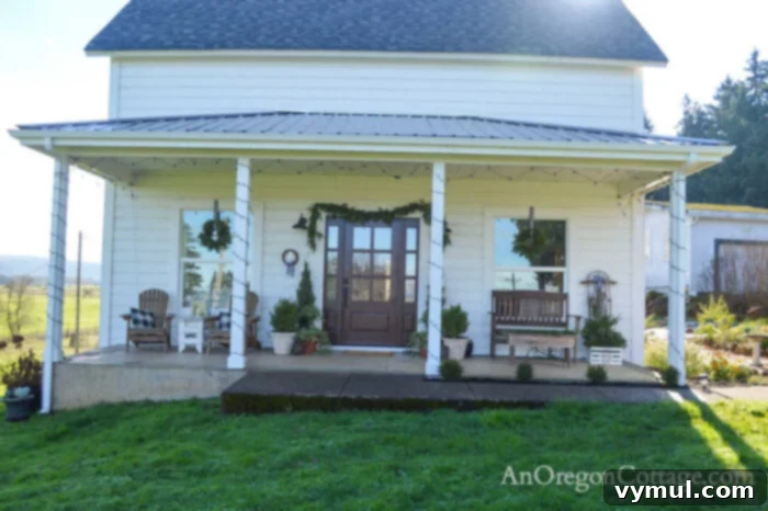 farmhouse Christmas porch with simple greenery and white lights, 2021