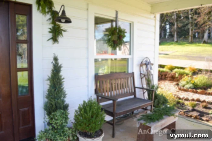 Cozy porch bench with buffalo check pillows and Christmas greenery