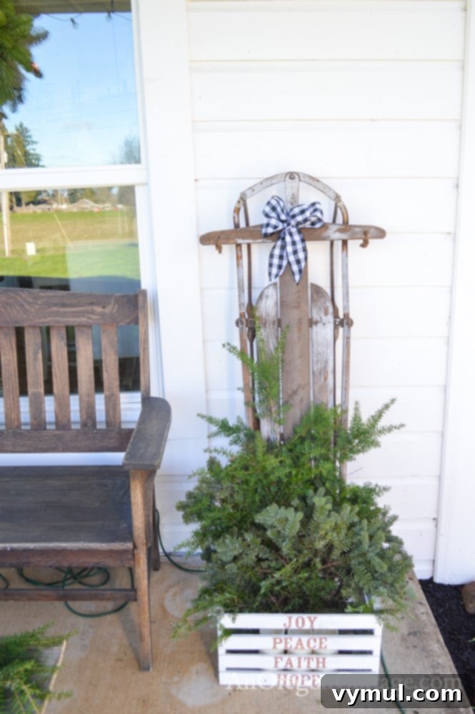 Vintage wooden sled and deacon's bench on a farmhouse Christmas porch