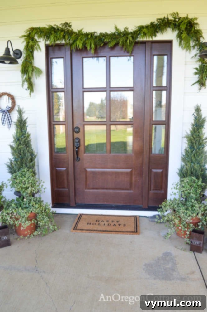 Christmas front door on a 1900 farmhouse with simple greenery and lights